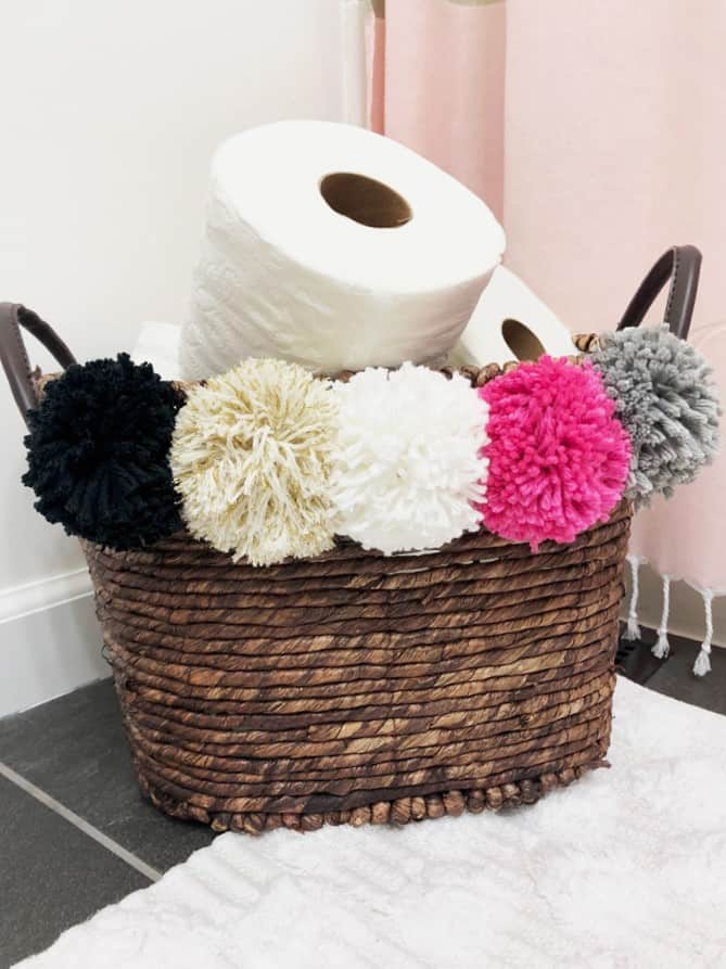 pom pom basket filled with toilet paper