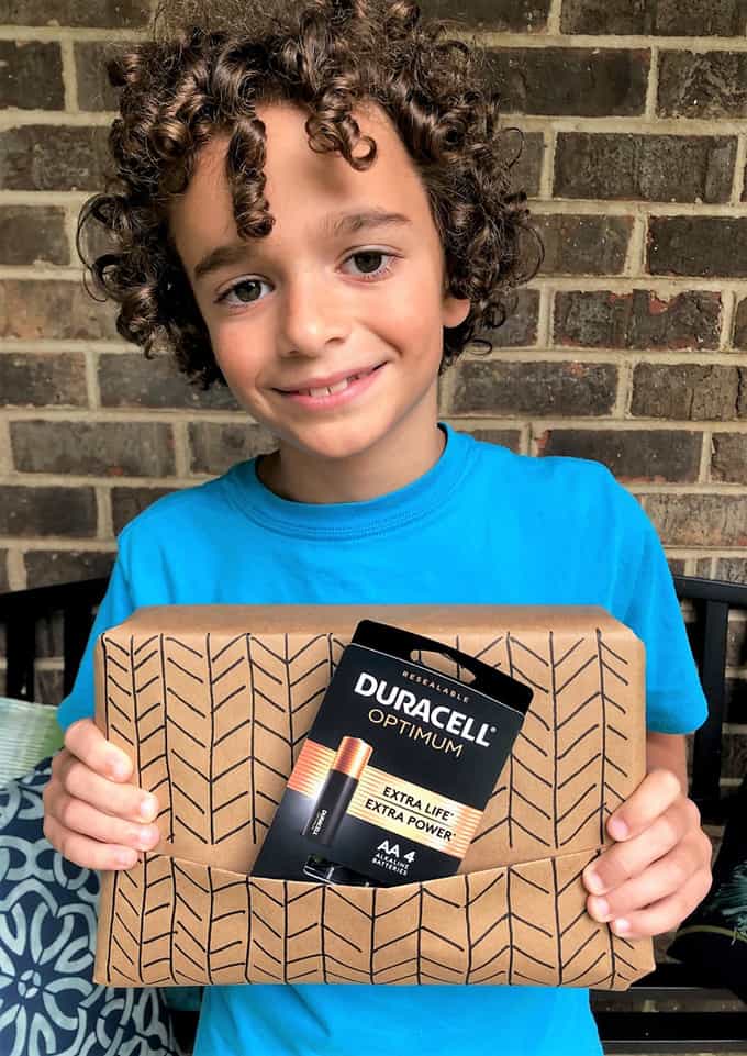 boy holding gift and batteries