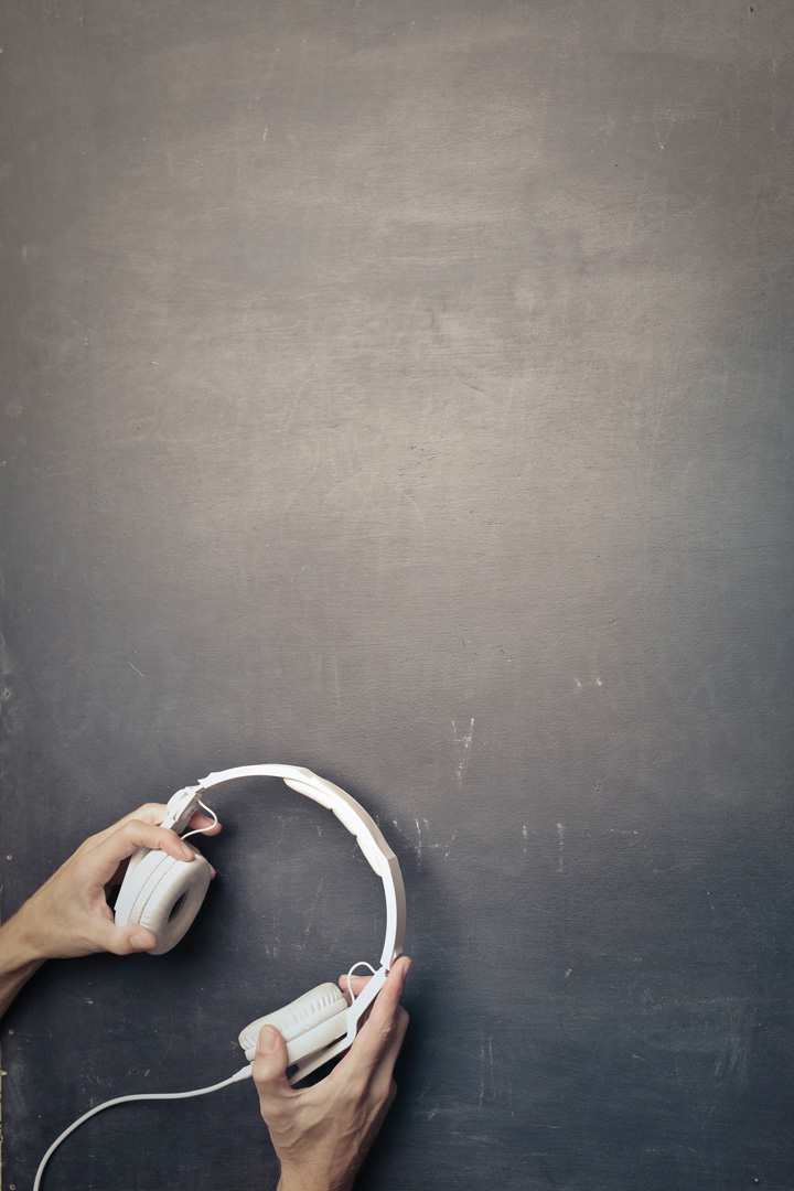 hands holding headphones