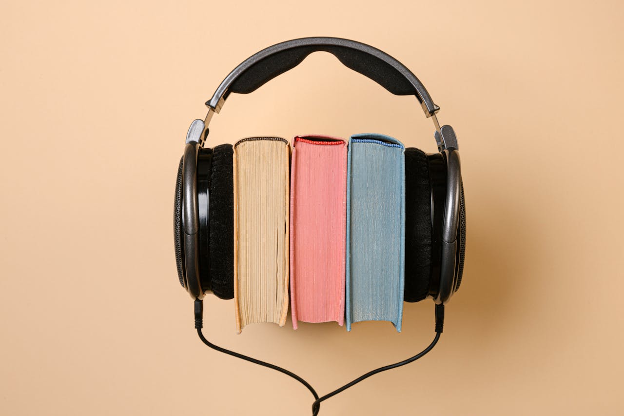 three books with headphones